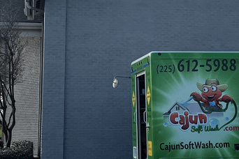 Cajun Soft Wash company truck parked near a building